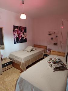 a hotel room with two beds and a tv at SELO APARTMENTS in Nea Kalikratia