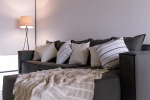 a couch with pillows on it in a living room at Duplex Alpha in Villa María