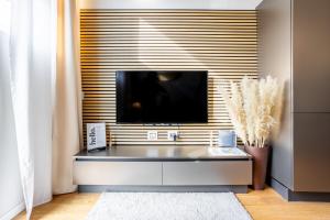 a living room with a flat screen tv on a wall at Duomo 9 - Luxury Modern Loft in Milan