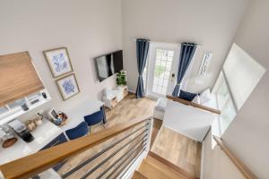 an overhead view of a living room with a staircase at SANDY - Cheerful 1 bedroom tiny house with pool in Dunedin