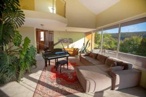 a living room with a couch and a piano at Villa Musica in Balchik