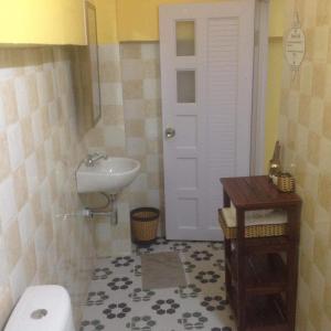 a small bathroom with a sink and a toilet at The Hideout in Kampot