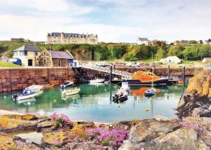 a group of boats are docked in a harbor at Ryan Bay in Dunragit