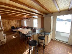 a kitchen with a table and chairs in a room at Chalet Rouge Gazon Altitude 1100m in Saint-Maurice-sur-Moselle