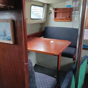 a small table and chairs in a train room at Sailing Yachts in Bergen in Bergen