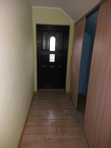 um corredor com uma porta preta e piso em azulejo em DAR-KAJ 