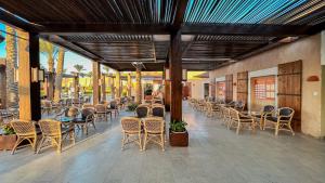 a row of tables and chairs on a patio at Gemma Resort in Marsa Alam City