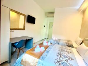 A bed or beds in a room at Santa Maria Accommodation