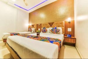 a bedroom with two beds in a room at Hotel BENTLY Terminal-2 in Mumbai