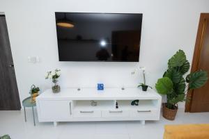 A television and/or entertainment centre at Happy to welcome you too modern