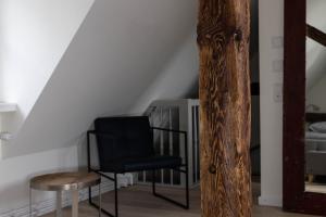 a black chair and a table in a room at Airstream Guesthouse in Basel