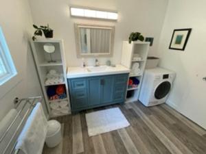 a bathroom with a sink and a washing machine at Sweet Creek Retreat in Nelson +19 photos