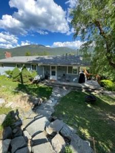 a house with a stone path in front of it at Sweet Creek Retreat in Nelson