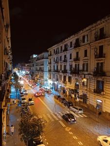a busy city street at night with cars parked at PèPè Bed & Breakfast in Naples