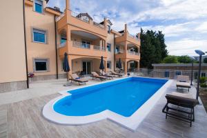 a villa with a swimming pool in front of a building at Villa Ljubica 2 in Vodice