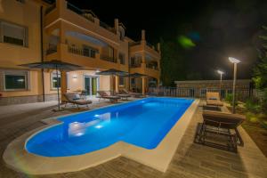 a swimming pool in front of a house at night at Villa Ljubica 2 in Vodice