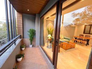 an internal view of a house with sliding glass doors at Hotel Gianmala Residency South Extension near AIIMS Delhi in New Delhi