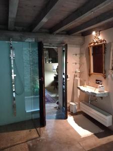 a bathroom with a shower and a sink and a mirror at BORGO DI BEPPE E GLORIA SUITE in San Giovanni Valdarno