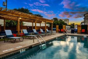 a pool with lounge chairs and a gazebo at Your Modern 2B Getaway - W/D, Pool, Prkg - 10min to DTWN in Austin