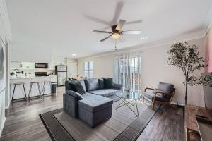 a living room with a couch and a table at Your Modern 2B Getaway - W/D, Pool, Prkg - 10min to DTWN in Austin