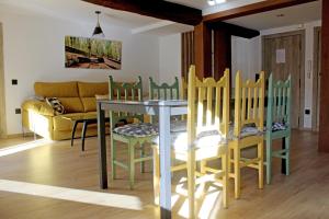 a living room with a table and chairs and a couch at Bosque de los sauces in Béjar +21 photos