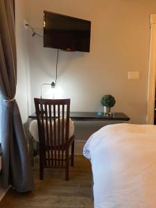 a bedroom with a desk with a chair and a television at Cozy Montreal Suites in Prime Location in Montreal