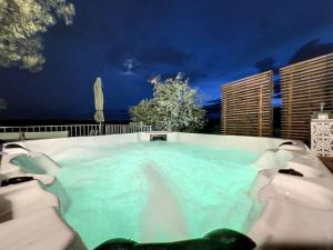 a large pool of blue water at night at Lodge Paradisiaque Spa in Cazouls-lès-Béziers