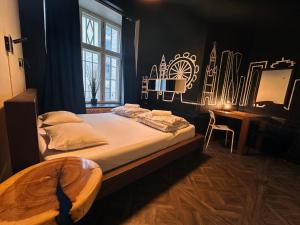 a bedroom with a bed and a desk and a window at Imaginary Hostel in Tallinn