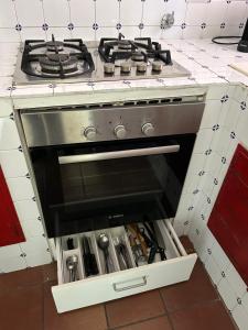 a stove top oven sitting in a kitchen at Villino "Il Rustichetto" in Genoa