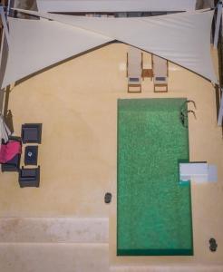 a room with a green door and some chairs at Olive Zen Villa Zante with Private Pool & Sunrise Sea View in Zakynthos