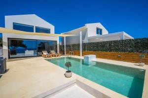 a house with a swimming pool in front of it at Olive Zen Villa Zante with Private Pool & Sunrise Sea View in Zakynthos +52 photos