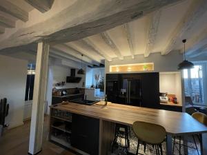 a kitchen with a wooden counter top in a room at L’ATYPIK in Chablis