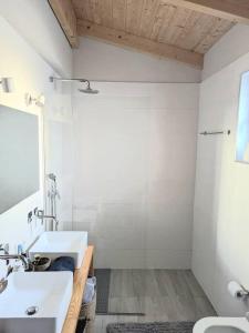 a bathroom with two sinks and a shower at Olive Zen Villa Zante in Zakynthos Town +56 photos