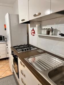 a kitchen with a stove and a sink at Seal Home in Genoa