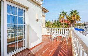a balcony with a table and chairs and a view of the water at Awesome Apartment In Torrevieja in Torrevieja +7 photos