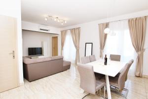 a living room with a white table and a couch at HAPPY DAYS in Trogir
