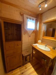 a bathroom with a sink in a log cabin at Chalet en rondins avec magnifique vue in Font-Romeu-Odeillo-Via