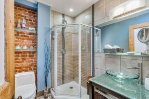 a bathroom with a glass shower and a toilet at Cozy Montreal Suites in Prime Location in Montreal