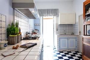 a kitchen with a black and white checkered floor at Dimora Birullà Luxury apartment in Modica