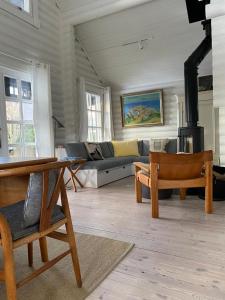a living room with a couch and a table and chairs at HAUS ZWEINEUN in Brodersby