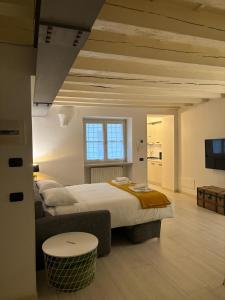 a large white bedroom with a large bed and a table at SanPietro in Verona