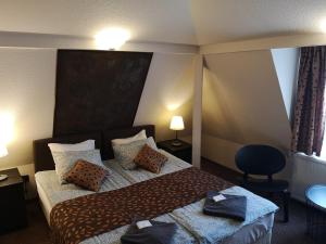 a hotel room with a bed with two pillows at Kikelet Panzio in Dunakeszi