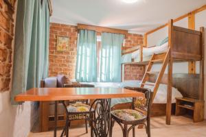 a small room with a bunk bed and a table and chairs at Apartment in Antique Museum Filip in Bitola