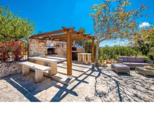 a patio with a picnic table and a pavilion at Trullo Olivia con piscina riscaldata, natura e relax in Martina Franca