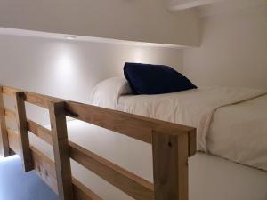 a bunk bed with a blue pillow on top of it at EF7 Beds & Family in Tarragona