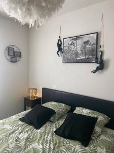 a bedroom with a bed with two pillows on it at Voyage en Touraine in Fondettes