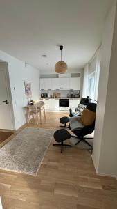 a living room with a couch and a table at Kokkola Charm - Central Apartment by University Center in Kokkola