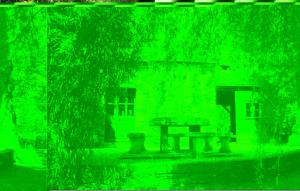 a green picture of a building with a bench at 2 Bedroom Nice Home In La Gacilly in La Gacilly