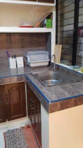 a kitchen with a sink and a counter top at Loidas place in Talisay
