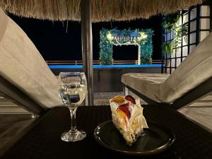 un piatto con un pezzo di cibo e un bicchiere di vino di Imperial Resort - Bali Themed - 1 Bed a Hurghada